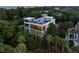 Stunning modern home with multiple balconies, a rooftop deck, and surrounded by lush greenery at 2213 Rolling Dune Rd, Seabrook Island, SC 29455