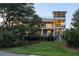 Charming three-story home with multiple balconies, lush landscaping, and a well-manicured lawn at 2213 Rolling Dune Rd, Seabrook Island, SC 29455