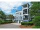 Three-story coastal home features screened porches, multiple balconies, and a ground floor garage at 2213 Rolling Dune Rd, Seabrook Island, SC 29455