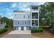 Beautiful three-story coastal home featuring screened porches, multiple balconies, and a spacious driveway at 2213 Rolling Dune Rd, Seabrook Island, SC 29455