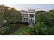 Gorgeous multi-story home surrounded by lush greenery, showcasing multiple balconies and inviting entrance at 2213 Rolling Dune Rd, Seabrook Island, SC 29455