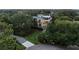 Stunning three-story home with multiple balconies, lush landscaping, and a charming driveway at 2213 Rolling Dune Rd, Seabrook Island, SC 29455