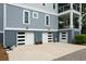 The ground floor garage has three bays and is equipped with modern doors and exterior sconces at 2213 Rolling Dune Rd, Seabrook Island, SC 29455
