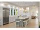 Eat-in kitchen with island and stools, stainless steel appliances, farmhouse sink, and hardwood floors at 2213 Rolling Dune Rd, Seabrook Island, SC 29455
