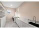 Spacious laundry room featuring built-in shelving, marbled countertop, and modern washer/dryer at 2213 Rolling Dune Rd, Seabrook Island, SC 29455