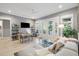 Spacious living room featuring a cozy sectional sofa, dining area, and balcony access with scenic views at 2213 Rolling Dune Rd, Seabrook Island, SC 29455