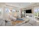 Cozy living room featuring a stone fireplace, built-in bookshelves, and comfortable seating at 2213 Rolling Dune Rd, Seabrook Island, SC 29455
