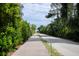 Scenic path leading to the beach with lush greenery and blue skies overhead at 2213 Rolling Dune Rd, Seabrook Island, SC 29455