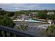 Elevated view of a community pool, surrounded by palm trees, lounge chairs, and a clubhouse at 2213 Rolling Dune Rd, Seabrook Island, SC 29455