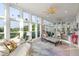 Sunroom featuring floor to ceiling windows, ceiling fans, and casual dining area at 2213 Rolling Dune Rd, Seabrook Island, SC 29455