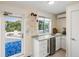 Entertaining is easy with this wet bar near the porch featuring stainless steel appliances and granite countertops at 2213 Rolling Dune Rd, Seabrook Island, SC 29455