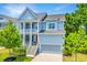 Charming two-story home featuring double porches, a grey garage door, and manicured landscaping at 2234 Mother Of Pearl Dr, Mount Pleasant, SC 29466
