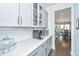 Modern kitchen with quartz countertops, glass-front cabinets, and stainless steel appliances at 2234 Mother Of Pearl Dr, Mount Pleasant, SC 29466