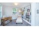 This home office features custom built-in shelving and natural light at 2234 Mother Of Pearl Dr, Mount Pleasant, SC 29466