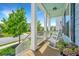 Inviting front porch with rocking chairs and a charming view of the neighborhood at 2234 Mother Of Pearl Dr, Mount Pleasant, SC 29466