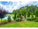 Beautiful backyard with a serene pond and lush, mature landscaping at 225 Camber Rd, Huger, SC 29450