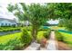 Beautiful backyard featuring mature trees, a pond, and garden arbor at 225 Camber Rd, Huger, SC 29450