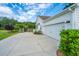 Charming home featuring a white exterior, an attached garage, and meticulously manicured landscaping at 225 Camber Rd, Huger, SC 29450