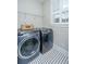 Convenient laundry room with modern appliances and black and white tile flooring; efficient and well-designed at 225 Camber Rd, Huger, SC 29450
