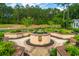 Stunning water fountain surrounded by lush greenery and landscaped gardens; creates a tranquil outdoor oasis at 225 Camber Rd, Huger, SC 29450
