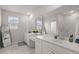 Elegant bathroom features double sinks, a large mirror, marble floors and plenty of natural light at 238 Bird Song Path, Summerville, SC 29485