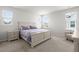 Spacious bedroom with large windows, neutral carpeting, and a beautifully appointed bed and side tables at 238 Bird Song Path, Summerville, SC 29485