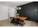 Bright dining room features a wooden table, black accent wall, and stylish chandelier lighting at 238 Bird Song Path, Summerville, SC 29485