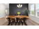 Bright dining room features a wooden table, black accent wall, and stylish chandelier lighting at 238 Bird Song Path, Summerville, SC 29485