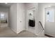 Hallway leading to laundry room featuring modern washer and dryer units, ensuring ease of chores at 238 Bird Song Path, Summerville, SC 29485
