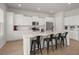Beautiful kitchen features white cabinets, stainless appliances, large island with seating, and hardwood floors at 238 Bird Song Path, Summerville, SC 29485