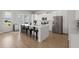 Bright, modern kitchen with stainless steel appliances, center island, and bar stool seating at 238 Bird Song Path, Summerville, SC 29485