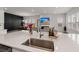This open-concept living space shows kitchen island, dining and living room with custom wall at 238 Bird Song Path, Summerville, SC 29485