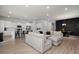 Open-concept living area showcases a modern kitchen, dining area, and comfortable sectional at 238 Bird Song Path, Summerville, SC 29485