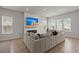Modern living area with a fireplace, large sectional sofa, and plenty of natural light at 238 Bird Song Path, Summerville, SC 29485