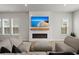 Comfortable living room features a modern fireplace, TV, and large sectional sofa at 238 Bird Song Path, Summerville, SC 29485