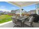Cozy covered patio featuring an outdoor dining table and grill, great for entertaining guests and relaxing at 238 Bird Song Path, Summerville, SC 29485