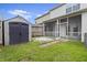 Spacious backyard featuring a storage shed and screened porch at 242 Swallowtail Ln, Goose Creek, SC 29445