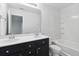 Bright bathroom featuring a double sink vanity with black cabinets and a shower-tub combo at 242 Swallowtail Ln, Goose Creek, SC 29445