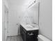This bright bathroom features double sinks with a dark cabinet and bright vanity lighting at 242 Swallowtail Ln, Goose Creek, SC 29445