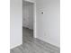 Hallway featuring gray flooring, an open door, and a thermostat mounted on the wall at 242 Swallowtail Ln, Goose Creek, SC 29445