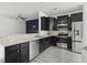 Well-lit kitchen featuring a breakfast bar, modern stainless steel appliances, and dark cabinetry at 242 Swallowtail Ln, Goose Creek, SC 29445