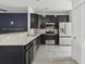 Modern kitchen with dark cabinets, stainless steel appliances, and granite countertops at 242 Swallowtail Ln, Goose Creek, SC 29445