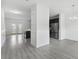 Bright, open-concept living space with gray wood floors and easy access to the kitchen and outdoor patio at 242 Swallowtail Ln, Goose Creek, SC 29445