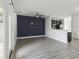 Bright living area with a shiplap accent wall, recessed lighting, and access to the kitchen at 242 Swallowtail Ln, Goose Creek, SC 29445