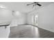 Open living area featuring gray wood floors, a ceiling fan, and access to an outdoor patio at 242 Swallowtail Ln, Goose Creek, SC 29445