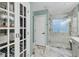 Elegant bathroom with marble shower, hexagon tile floor, and a linen closet at 2467 Bergeron Way, Mount Pleasant, SC 29466