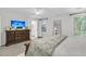 Relaxing main bedroom featuring a dresser with television and a glimpse into the bathroom at 2467 Bergeron Way, Mount Pleasant, SC 29466