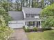 Aerial view of a two-story home with a charming front porch, mature trees, and attached garage at 2467 Bergeron Way, Mount Pleasant, SC 29466