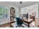Bright home office with desk, shelving, hardwood floors, and plantation shutters at 2467 Bergeron Way, Mount Pleasant, SC 29466
