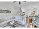 Bright and airy living room with a cozy sofa and seamless flow to the dining area at 2467 Bergeron Way, Mount Pleasant, SC 29466